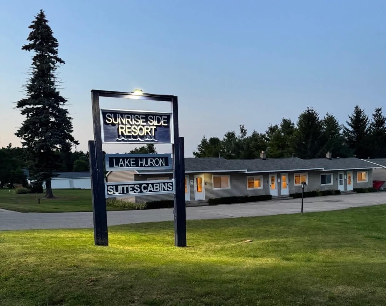 Sunrise Side Resort sign and suites at dusk